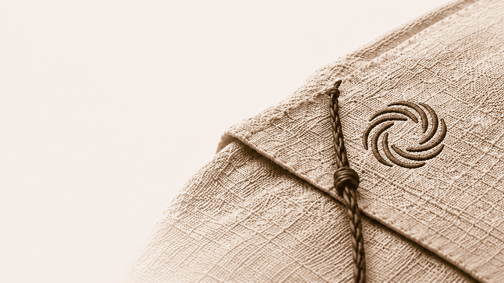 Close-up of a woven linen bag with Mettle Thread embroidery